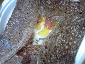 Egg, tomato, ham, and cheese crepe